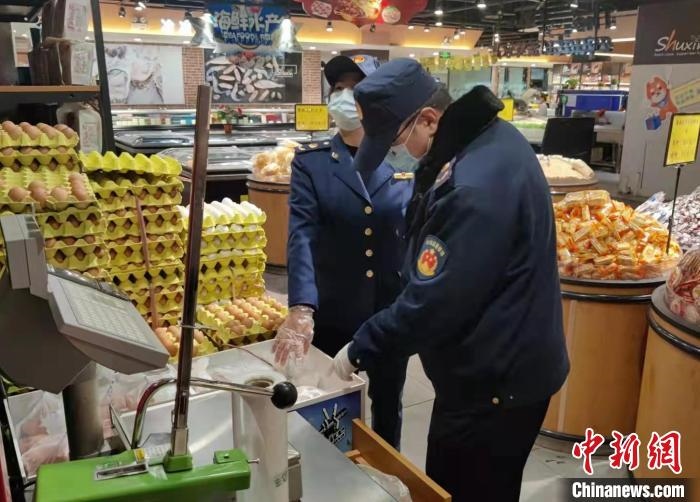 圖為疫情期間，甘肅嘉峪關(guān)市場(chǎng)監(jiān)管局工作人員檢查蔬菜市場(chǎng)。　 柴佳楠 　攝
