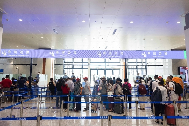 乘坐中老鐵路國際旅客列車的旅客在磨憨邊檢大廳排隊候檢。黃遠(yuǎn)飛 攝