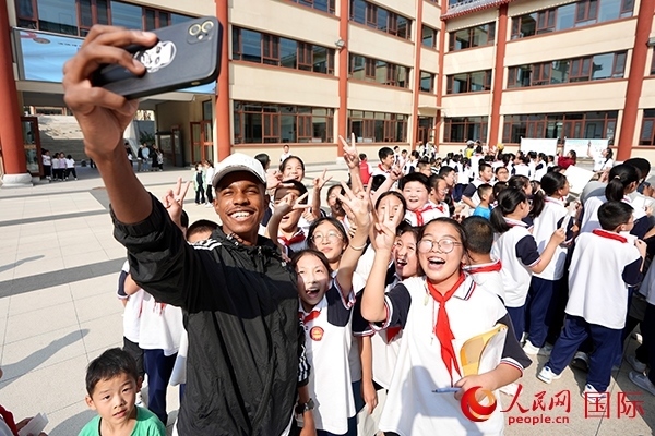 選手和學(xué)生們合影。人民網(wǎng) 盧鵬宇攝