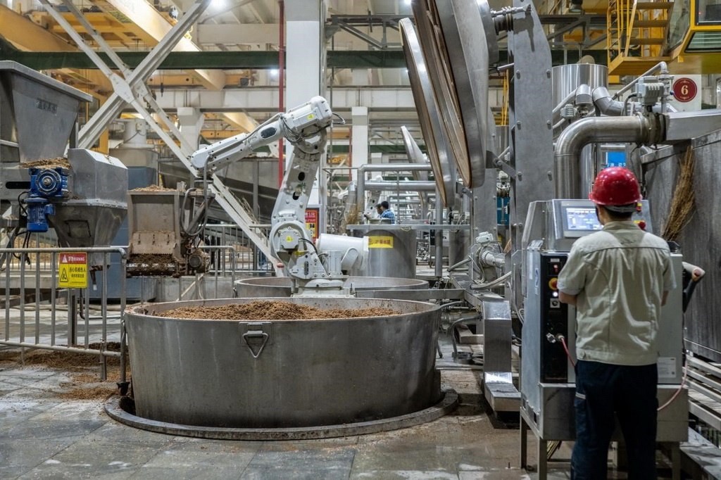 907車間里，機(jī)械臂正在撒料裝甑。嚴(yán)磊攝