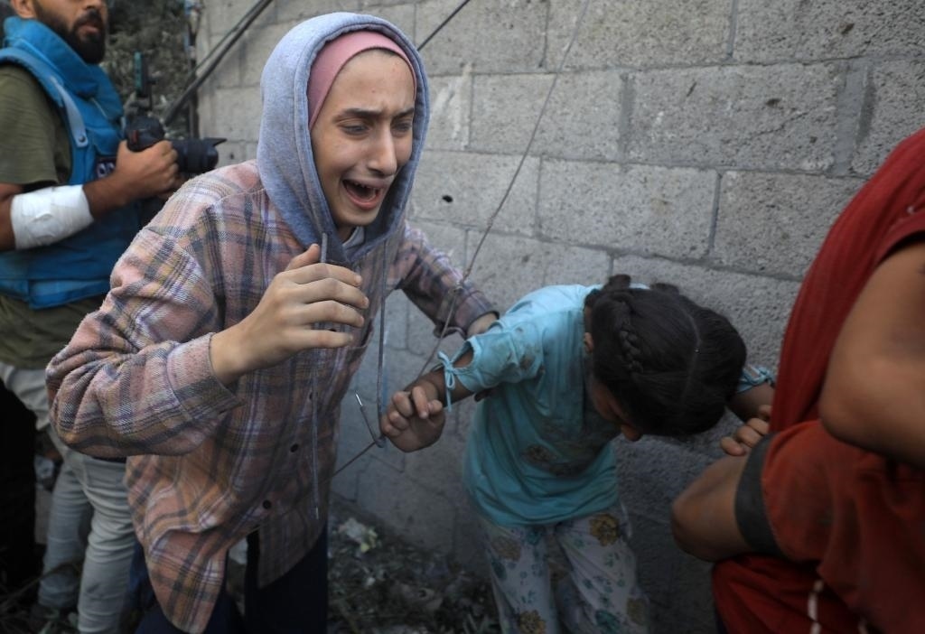 11月6日，人們從加沙地帶中部地區(qū)一處被炸難民營逃離。新華社發(fā)（亞西爾·庫迪攝）