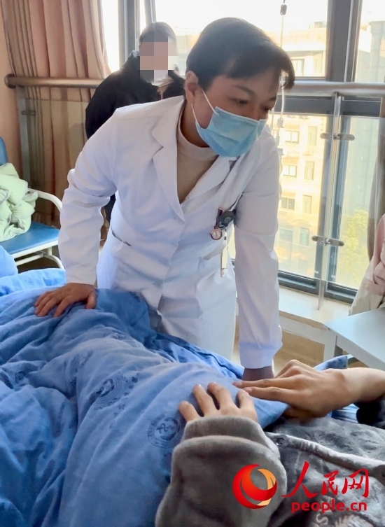 鄧茜查房時詢問患者情況。人民網(wǎng)記者 金慧慧攝